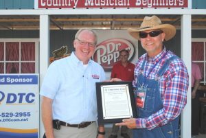 Sixth District Congressman John Rose praised the Fiddlers Jamboree for reaching this 50 year milestone and presented festival President and Coordinator Sam Stout a framed copy of his remarks on the floor of the US House of Representatives made part of the Congressional Record