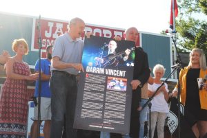 Darrin Vincent, with help from County Mayor Tim Stribling, unveils and displays his “Tennessee Music Pathways” marker honoring him