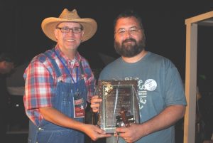 Justin Branum of Murfreesboro has claimed the Grand Champion Fiddling Title at the Smithville Fiddlers Jamboree and Crafts Festival. Sam Stout, President and Coordinator of the Fiddlers Jamboree (left) presented the award to Branum at the conclusion of the festival which ended at 11:15 p.m. Saturday evening, July 3.