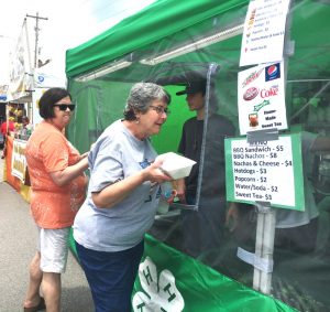Jan Thomas (right) having lunch at the 4-H food booth during the Fiddlers Jamboree