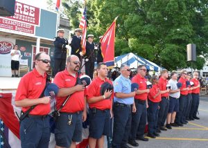 Members of the Smithville Volunteer Fire Department post colors during Open Ceremony of the Fiddlers Jamboree Friday