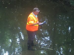 Shawn Puckett of TDEC taking measurements in Hickman Creek behind Alexandria Senior Citizens Center