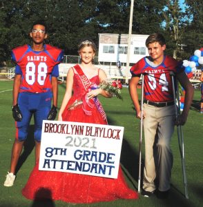 8th grade DeKalb Middle School attendant Brooklyn Blaylock. Her escorts were Jerett Hamilton (left) and Aiden Turner (right)