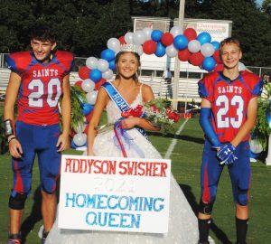 Addyson Grace Swisher is the 2021 Saints Homecoming Queen. Her escorts were Wyatt Carter (left) and Hunter Buchanan (right)