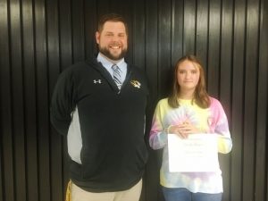 DCHS Assistant Principal Thomas Cagle presents a certificate to 11th grader Serenity Faith Burgess, daughter Joshua and Tristan Burgess, as Student of the Month for November.