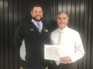 DCHS Assistant Principal Thomas Cagle presents a certificate to Junior and Senior English Educator Chris Vance as Teacher of the Month for November.