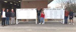 The “Love Lights A Tree” display board for the American Cancer Society has undergone a renovation thanks to the carpentry class and others at DeKalb County High School. Pictured left to right: DCHS students Isaiah Taylor, Gavin Cool, Carpentry teacher Gary Caplinger, and students Anderson Burnett, Kyra Baker, Kyle Miller, and Aydan Bean