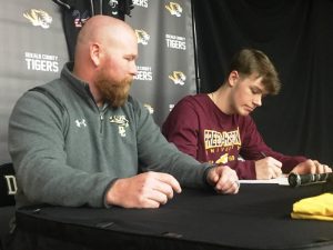 DCHS Tiger Baseball Coach Tad Webb looks on as Patrick Cantrell, a senior and ace pitcher for the DCHS Tiger baseball team signs a letter of intent with Freed-Hardeman University to play collegiate ball for the Lions after he graduates.