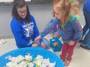 Mrs. Leah Magness watches as Ansley Snow fishes for math facts