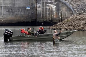 Park Ranger Gary Bruce maneuvers a Corps of Engineers boat into position Nov. 2, 2021 to allow an Open Jaw Productions film crew to obtain imagery of Lee Chadwell fly fishing in the Caney Fork River below Center Hill Dam in Lancaster, Tennessee. Trout fishing is a popular recreation activity in the tailwater at the project operated and maintained by the U.S. Army Corps of Engineers Nashville District. The imagery is being used for a USACE National Inventory of Dams video production. (USACE Photo by Lee Roberts)