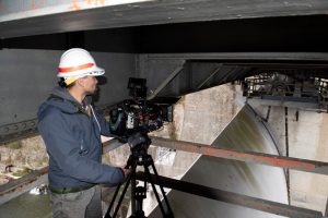 Director Zebediah Smith with Open Jaw Productions captures video of a spillway gate Nov. 3, 2021 at Center Hill Dam on the Caney Fork River in Lancaster, Tennessee, for a U.S. Army Corps of Engineers National Inventory of Dams video production. (USACE Photo by Lee Roberts)