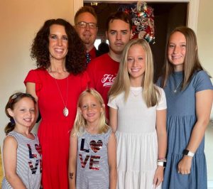 Local Author Holly Moore (pictured in red dress with her family) Pens Book: Broken Being a Victor, Not a Victim
