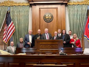 “I’ll Leave My Heart in Tennessee” by Grand Ole Opry stars Dailey & Vincent and written by Karen Staley is now an official state song of Tennessee after legislation sponsored by Sen. Paul Bailey (R-Sparta) and Rep. John Windle (D-Livingston) was signed into law by Gov. Bill Lee earlier this month. Pictured (L to R): Senator Paul Bailey, Grand Ole Opry Executive Coordinator Dan Rogers, Producer Paul Worley, Jamie Dailey, Lt. Governor Randy McNally, Darrin Vincent, House Of Representatives member John Mark Windle, Springer Mountain Farms Chicken’s Gus Arrendale, Ben James, and songwriter Karen Staley. Photo courtesy of Dailey & Vincent.