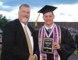 Principal Bruce Curtis presents Isaiah Harrington with Citizenship Award at DCHS graduation in May