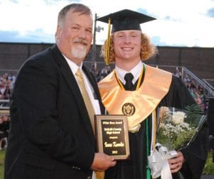 Principal Bruce Curtis presents Isaac Knowles with White Rose Award at DCHS graduation in May