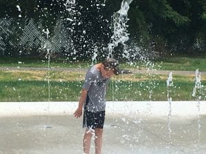 Youngster enjoys getting doused at Splashpad