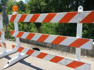 Small narrow bridge on Dry Creek Road at intersection of West Broad reduced to one lane after hole (shown here) developed through the bridge