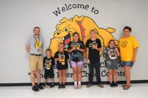 Run for the Bulldog winners pictured left to right with Assistant Principal Seth Willoughby are Maddox Walter, Eden Donnell, Rebekah Goss, Timothy Goss, and Sydney Turner and PTO President Shelly Barnes