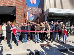 The City of Smithville and Chamber of Commerce held a dedication ceremony and ribbon cutting for the John Anderson Alley, formerly known as Walnut Alley. The alley was recently renamed in honor of the Country Music Icon, who has made Smithville his home for more than 40 years. At one time John and his wife Jamie owned a downtown building attached to the alley.