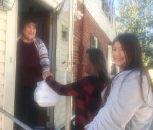 Becky Atnip and Christina Snipes deliver Thanksgiving Day Meals on behalf of the DeKalb Emergency Services Association to Debra Black on South Third Street.