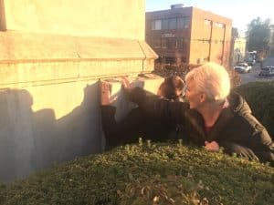 County Mayor Matt Adcock and Chamber Director Suzanne Williams removing the concrete cover where the courthouse time capsule was once hidden