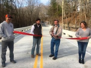 Now Open! After seven months, motorists traveling Big Rock Road no longer have to detour because the new bridge over Pine Creek is now completed. Road Supervisor Danny Hale held a ribbon cutting at the bridge in December accompanied by his secretary Rena Willoughby; the Project Engineer, Kyle Hazel of Hazel Engineering, LLC in Cookeville (pictured far left); and Project Manager Justin Garmany of Dement Construction in Jackson (pictured second from left).