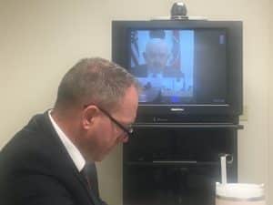 Parole Board Chairman Richard Montgomery presided over the parole hearing for Albert Fisher Tuesday. The hearing was held at the prison in Nashville where Fisher is incarcerated. Assistant District Attorney General Greg Strong participated in the hearing by video conference from Cookeville. Strong is shown here with a TV screen in the background showing Parole Board Chairman Montgomery