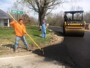 Road Supervisor Danny Hale oversees paving of Barnes Mill Road near intersection with Highway 288 in the Antioch area.