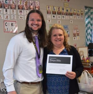 Assistant Principal Seth Willoughby presents Kindergarten Teacher Tonya Ellis with Teacher of the Month for May. Mrs. Ellis has been teaching for 28 years.