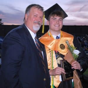 DCHS Principal Bruce Curtis presented the prestigious White Rose Award to Valedictorian Robert Wheeler during Friday night’s commencement ceremony