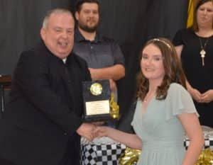 Serenity Burgess receives the Louis Armstrong Award from Director Don Whitt at the DCHS Band Banquet.