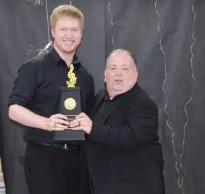 Director Don Whitt presents Gavin Conger with the highest band award, the John Phillips Sousa award.