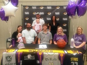 DCHS Senior Basketball Standout Elishah Ramos has signed with Bethel University to play for the Wildcats. Members of Ramos’ family joined him for the signing Tuesday, May 9 including seated left to right: Nalia Brown, Kova Brown, Eddie Ramos, Elishah Ramos, Rachel Bain, and Nola Bain. Standing left to right-Caleb Brown, Kahlia Brown, and Terra Hunt