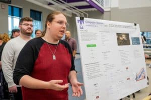 Tech students design database for Smithville Fiddlers' Jamboree Picture shows teammate Earl Pike giving a presentation