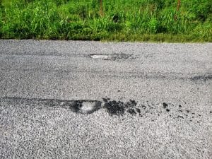 Damage to some freshly paved or tarred and chipped county roads by people doing “burnouts” with their vehicles is causing a problem for the DeKalb County Highway Department and Road Supervisor Danny Hale needs your help in catching the culprits. Photo shows damage at one location on Big Woods Road