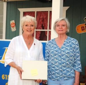 State Senator Janice Bowling presented a flag to Sue Conger, formerly of Smithville, who now lives in Camas, Washington who came from the greatest distance within the United States to be in Smithville for the Fiddlers Jamboree