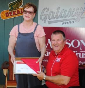 State Representative Michael Hale presented a flag to Elise Fleming of Memphis who came from the greatest distance within the state to be in Smithville for the Fiddlers Jamboree