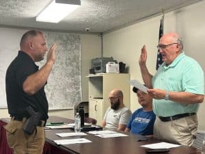 Travis Bryant takes oath of office as new Alexandria Police Chief from Alexandria City Attorney Vester Parsley during Tuesday night’s monthly meeting of the Alexandria Mayor and Aldermen