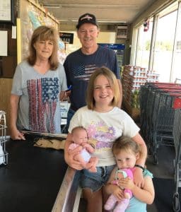 Larry and Deborah Hancock, owners and operators of Larry’s Discount Grocery for 43 years in Smithville, shown here with Hadley Mitchell and Henleigh Mitchell, granddaughters of Tina Moony (not pictured here) who were with their grandmother shopping Monday morning.