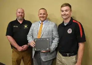 The DeKalb County Fire Department received special recognition during Monday night’s County Commission meeting from the Tennessee Fire Service and Codes Enforcement Training Academy to commemorate the unit having been named, for the 15th consecutive year, as an “Elite” Training Department in Tennessee. Director Jason Sparks (center) presented the award to the DeKalb Fire Department’s outgoing training officer Captain Brian Williams (left) and the incoming officer Luke Green (right) to accept on behalf of the department and DeKalb County.