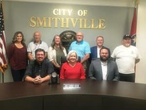 After a 34 year association with the City of Smithville, Janice Plemmons-Jackson is stepping down as its Certified Municipal Financial Officer. Pictured seated left to right: City Administrator Hunter Hendrixson, CMFO Janice Plemmons-Jackson, and Mayor Josh Miller. Standing left to right: Aldermen Beth Chandler, Don Crook, and Jessica Higgins, City Attorney Vester Parsley, and Aldermen Shawn Jacobs and Danny Washer