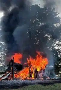 A fire Thursday afternoon destroyed a shop/garage building behind a residence at 4231 Seven Springs Road belonging to Davey Ferrell. (Photo by Carsyn Beshearse)