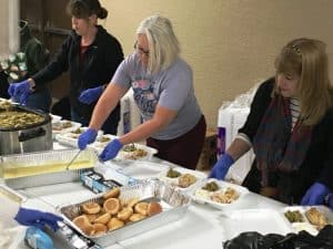 DESA Volunteers preparing food trays for delivery Thanksgiving.