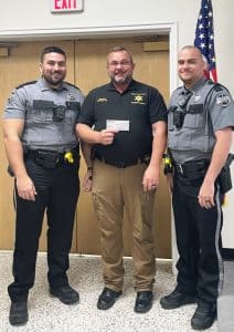 The DeKalb County Sheriff’s Department D.A.R.E. Program has been presented a $500 donation from Bruce Schaffer and Brian Clark with the Mountain Harbour Property Owners Association (POA). DeKalb Sheriff’s Department D.A.R.E. Officers Billy Tiner (right) and Joseph Carroll (left) along with Sheriff Patrick Ray accepted the donation