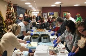 DESA volunteers filling the food trays