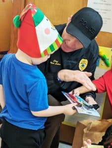 Smithville Police Chief Mark Collins presents gifts to Head Start child (Shawna Willingham photo)