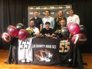 Outstanding DCHS senior football defensive lineman Wil Farris signed a letter of intent with Cumberland University in Lebanon to play for the Phoenix next season. Pictured here with DCHS coaches: Seated left to right-.Michael Shaw, Wil Farris, and Head Coach Steve Trapp. Standing left to right: Luke Green, Eli Cross, Cason Wheeler, Lucas Phillips.