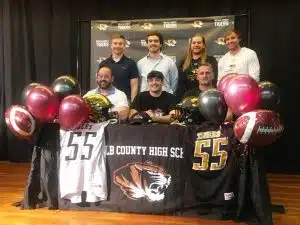 Outstanding DCHS senior football defensive lineman Wil Farris signed a letter of intent with Cumberland University in Lebanon to play for the Phoenix next season. Pictured here with DCHS coaches: Seated left to right-.Michael Shaw, Wil Farris, and Head Coach Steve Trapp. Standing left to right: Luke Green, Eli Cross, Cason Wheeler, Lucas Phillips.
