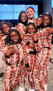 Annabella Dakas hangs with some of the Ugandan children in the Sozo Children's Choir after services at Smithville First Baptist Church. (Photo: Mandy Dakas)