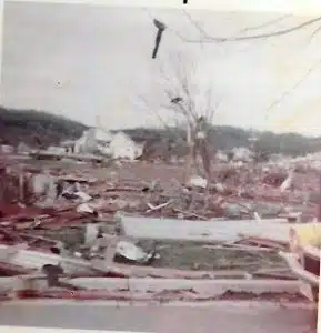 Twisted tin and other debris were left hanging in trees at Dowelltown and on the hillsides where the storm took its path